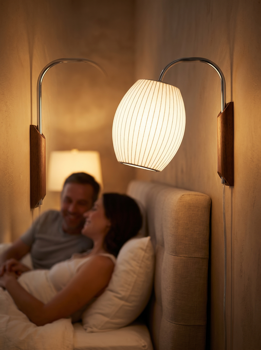 Nelson bubble swivel wall sconce beside a headboard