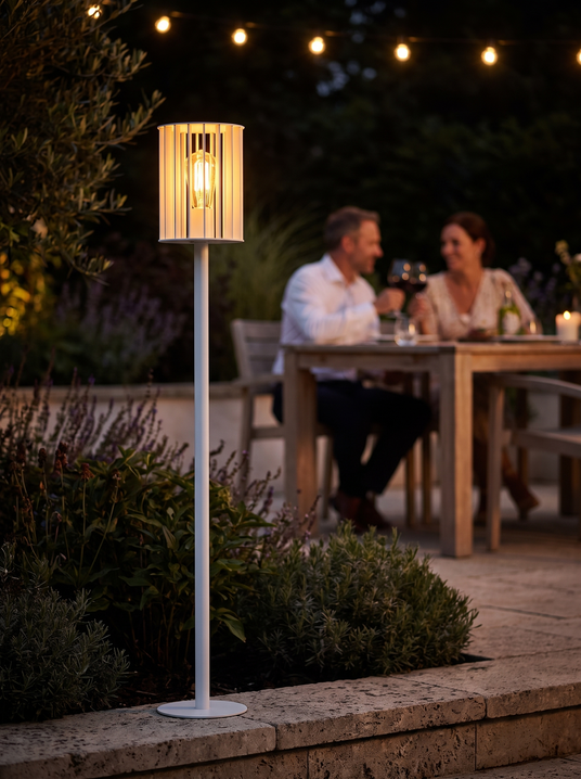 Colby column with a visible filament at a terrace edge with a couple dining at night