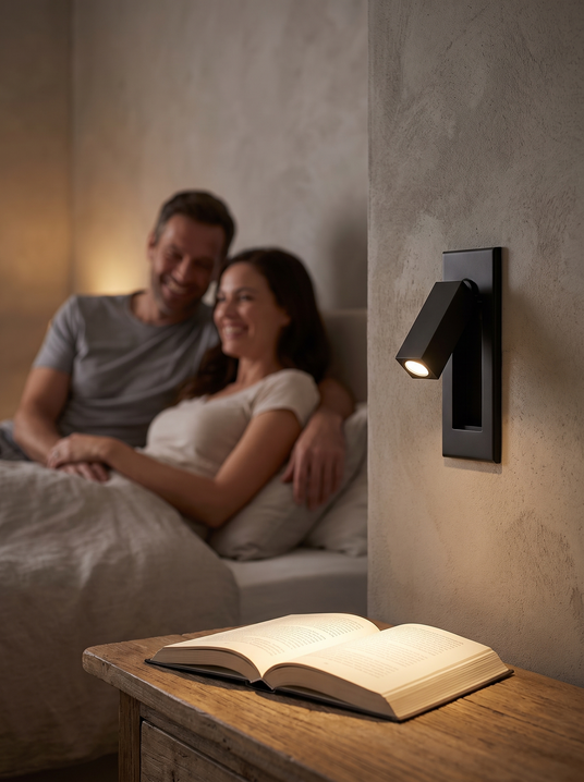 Recessed folding bedside sconce beside a guest bed