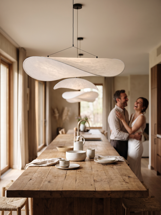 Tense oval silk pendant above a long dining table