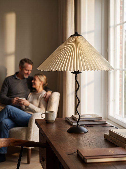 Squiggle wavy table lamp on a desk beside a window
